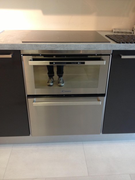 My feets reflected in a combo oven-dishwasher. The kind of space-saving ingenuity you find in Europe. About €1200. Not sure I'll splurge.